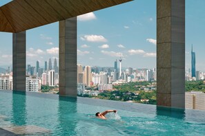 A swimming pool with a cityscape view, including a tall tower and a modern skyscraper. - Hyatt Regency Kuala Lumpur At KL Midtown (Kuala Lumpur)