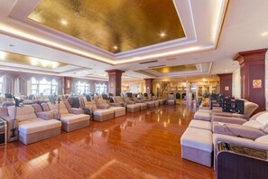 A spacious hotel lobby with a polished wooden floor, multiple seating areas, and a grand ceiling. - Huaining Hongbo All Seasons Hotel (Huaining)