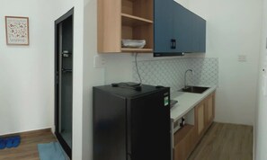 Standard Apartment | Private kitchen | Fridge, microwave, stovetop, dining tables