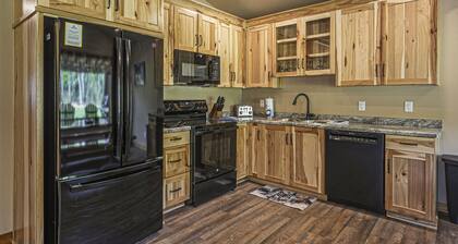 Modern dog-friendly cabin with hot tub, gas fireplace, patio, grill, & washer/dr