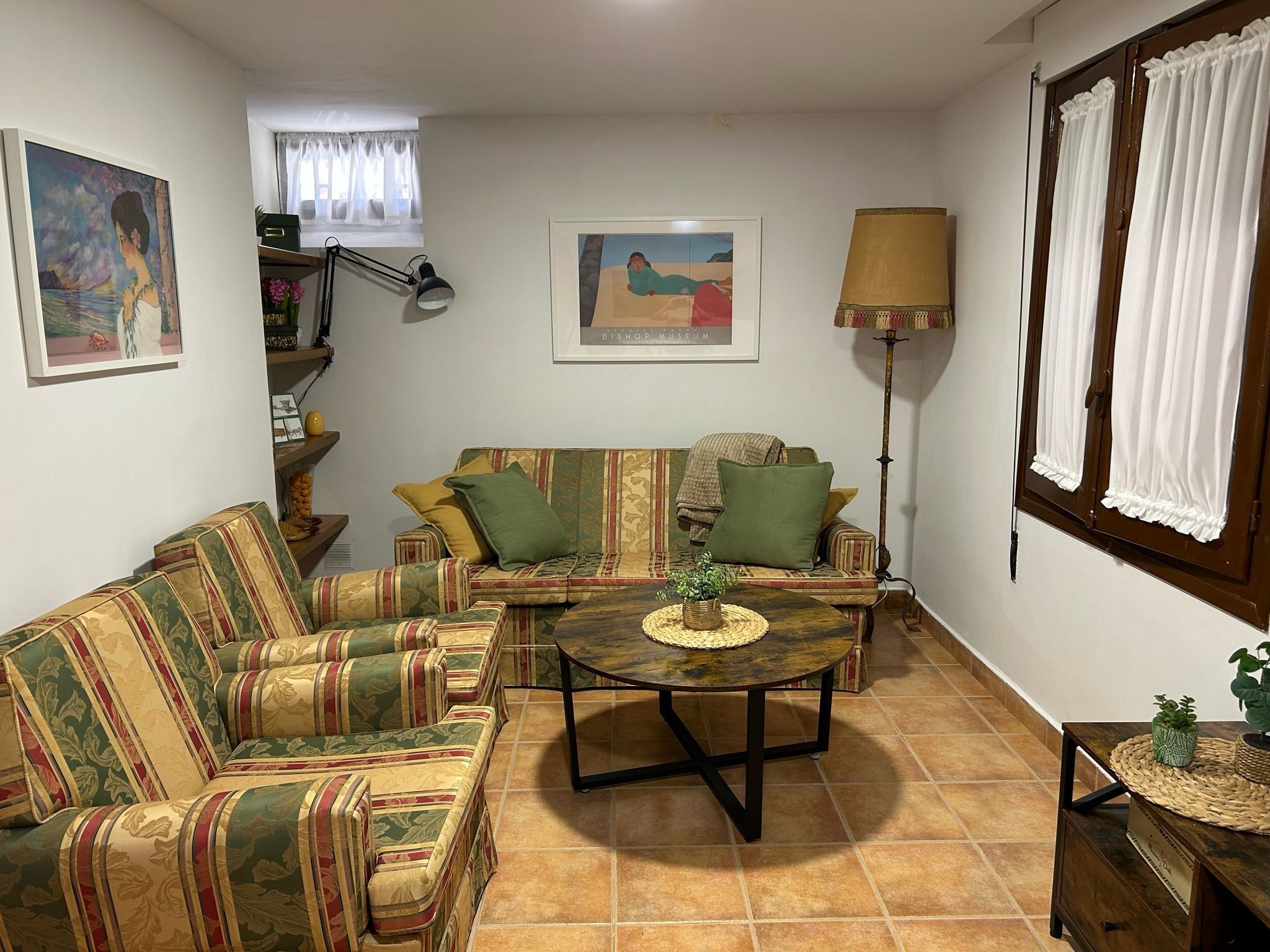 A living room with a sofa, a coffee table, and a lamp.