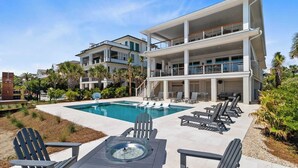 A modern two-story building with a pool and outdoor seating area. - 712 Ocean Blvd by Avantstay New Construction w/ Pool, Game Zone, Private Beach Access, and Oceanfront Views (Isle of Palms)