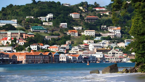 A coastal town with buildings on a hillside overlooking the sea.