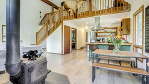 A rustic kitchen with a wooden staircase, a large stove, and a dining area with benches. - Steps to Crystal River: Hideaway w/ Mountain Views (Marble)