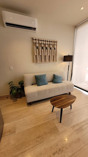 Relax in this stylish living room with a sofa, coffee table, and floor lamp.