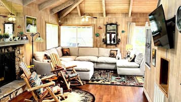 Smart TV, fireplace, books, computer monitors