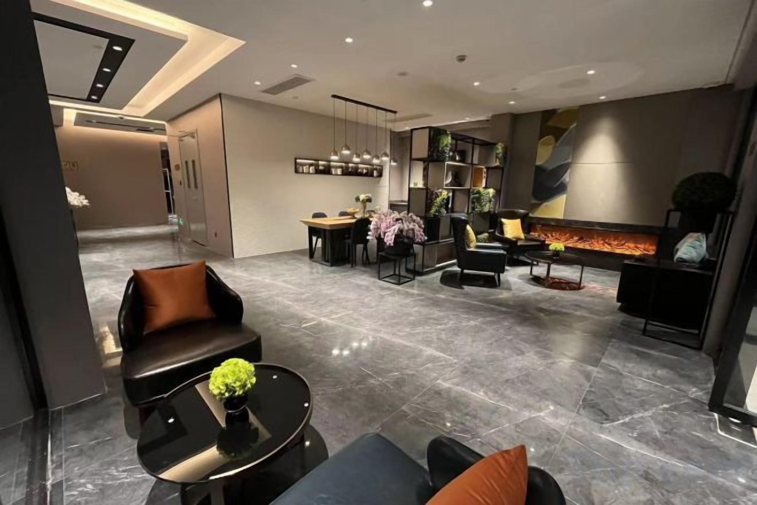 A modern interior with a seating area, a dining space, and a fireplace.
