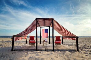 Relax under the shaded gazebo, surrounded by the expansive beach and ocean views.