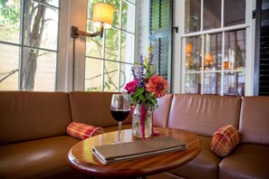 Relax in a comfortable seating area with a sofa, round table, and beautiful views of the surrounding greenery.