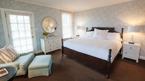 Classic design bedroom with a large bed, bedside tables, and a dresser, perfect for a comfortable stay.