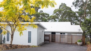 Situated in a suburban setting, this single-story home features a gabled roof and a front garage door.