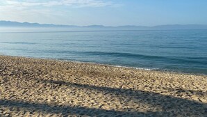 A beach with a pebbly shore and calm water. - Beach and Pool Access! (Puerto Vallarta)