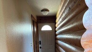 A narrow hallway with wooden flooring and a wooden wall on one side. - Charming 3-bedroom cabin in Victor only 25 miles from Jackson Hole, pet friendly (Victor)