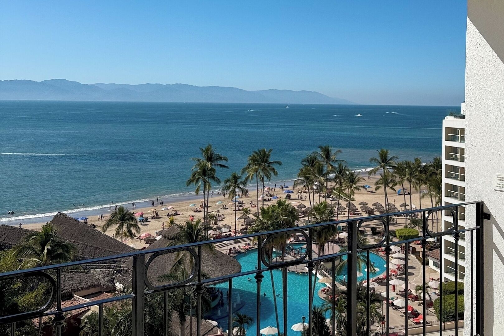 A resort with a pool, beach, and ocean view.