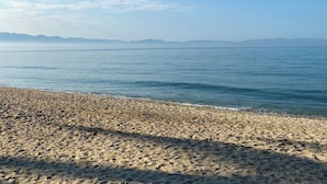 A beach with a pebbly shore and calm water. - Suite with Smart TV, WiFi and beach access! (Puerto Vallarta)