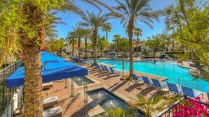 A resort pool area with palm trees, lounge chairs, and a clear blue sky. - Legacy Villas- 1 BR Suite with separate Living Room,Patio, Views,Sleeps 4-064225 (La Quinta)