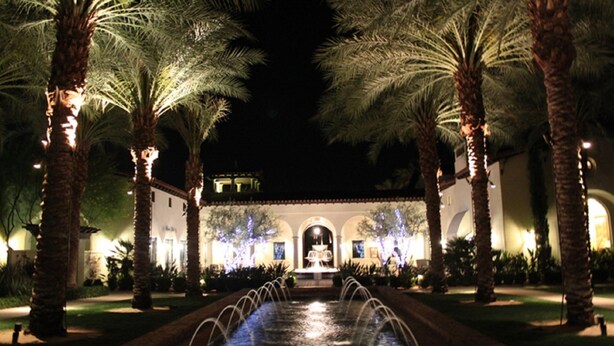 A nighttime view of a hotel courtyard with a water feature, palm trees, and illuminated architecture. - Legacy Villas- 1 BR Suite with separate Living Room,Patio, Views,Sleeps 4-064225 (La Quinta)