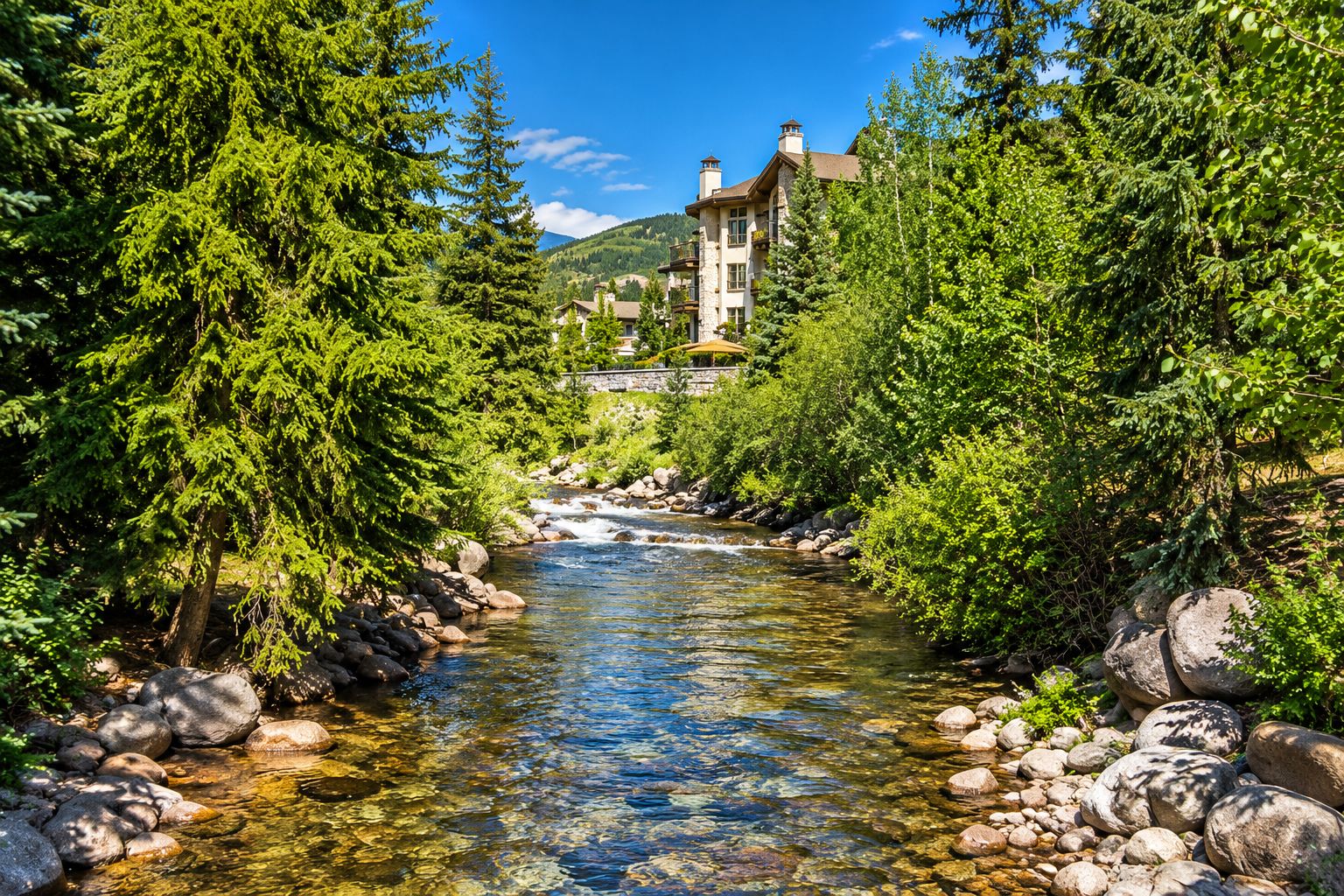 A river flowing through a forest with a stone building in the background.