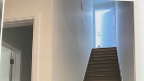 A staircase leading to a landing with a door at the top. - New 2 bedroom apartment in Toronto 
782 St. Clair ave.west (Toronto)