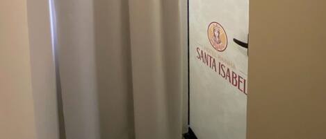 A hotel room with a sliding door marked "HOTEL SANTA ISABEL".