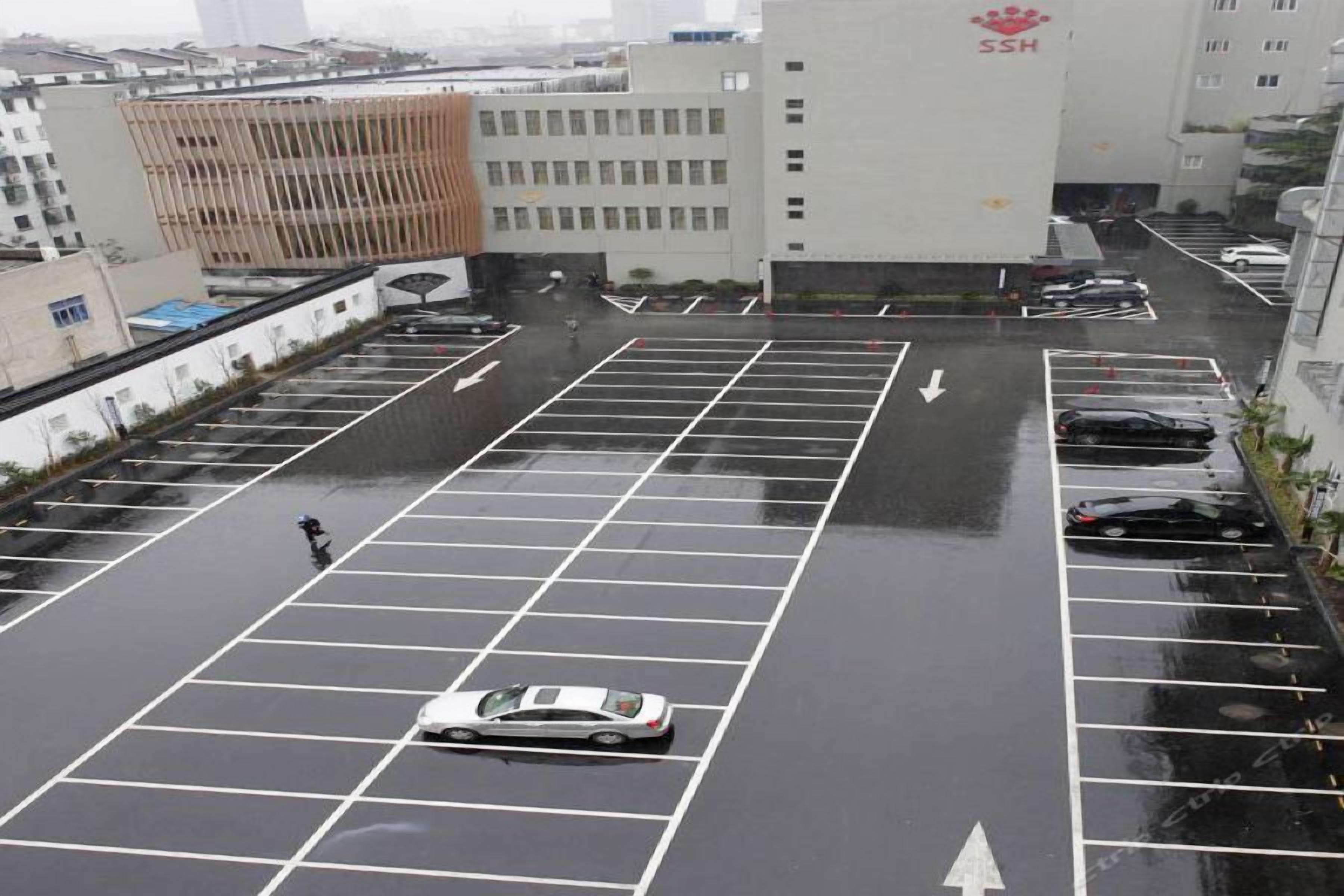A multi-level parking structure with clear directional arrows on the ground.