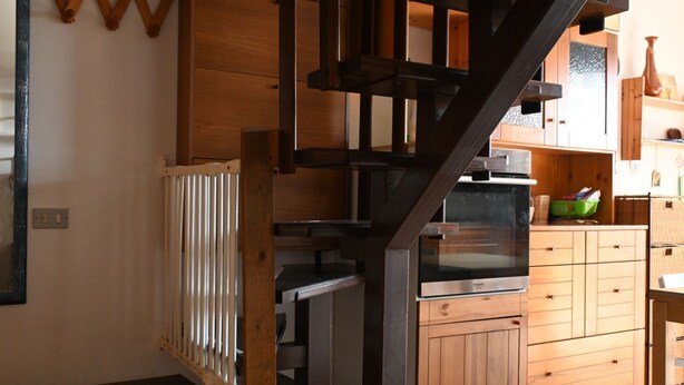 A kitchen with wooden cabinets, a built-in oven, and a staircase. -  M419 – Marcelli, one bedroom apartment eith terrace and air conditioning (Marcelli)