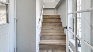A staircase with wooden steps and white walls, leading to a landing with a window. - Walk to Dtwn Show Low: Townhome w/ Balcony (Show Low)
