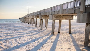 A pier extending into the ocean with a clear sky above. - Tropical Feel, Heated Pool, Hot Tub, Game Room, Mini Golf (Panama city beach)
