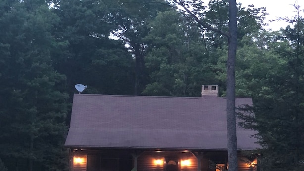 A lodge with a fire pit and outdoor seating by a pond. - Clearfield Co Rockton PA - Cabin Escape (Rockton)