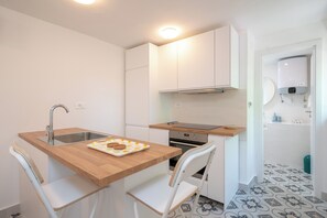 Apartment, Sea View | Private kitchen | Full-sized fridge, oven, stovetop, dishwasher