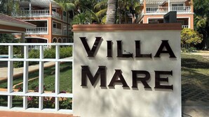 A sign for Villa Mare with a white fence and palm trees in the background. - Villa Mare B3 (on the beach Bavaro) Los Corales (Punta Cana)