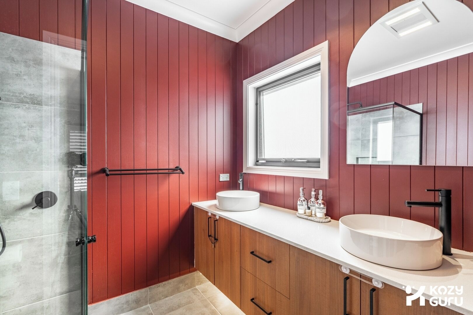 A vivid and bold interior wall detail in deep red, matching the design aesthetic of the earlier bathroom.