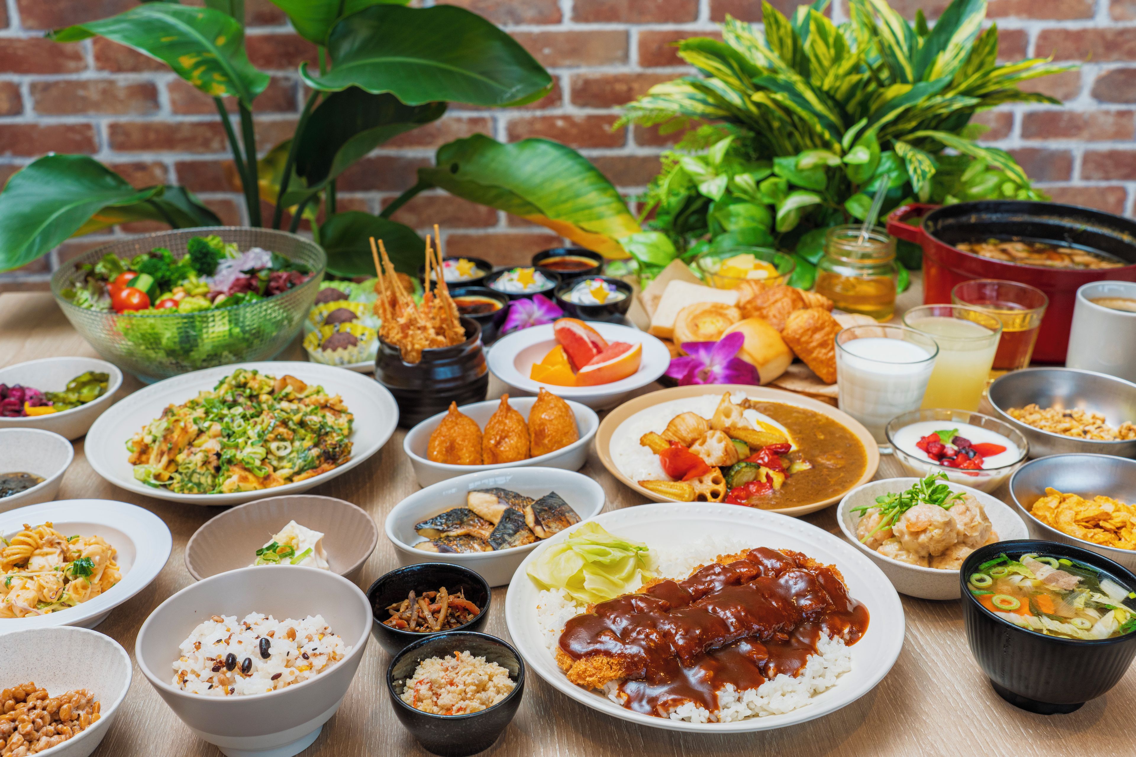 A variety of dishes on a table, including rice, vegetables, and meat dishes.