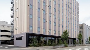 A tall, modern hotel building with a prominent sign at the top.