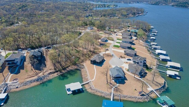 An aerial view of a lakeside residential area with houses and docks. - Accessible Lakeside Luxury at the 45mm w/ Private Dock, Sunset Views & More (Climax Springs)