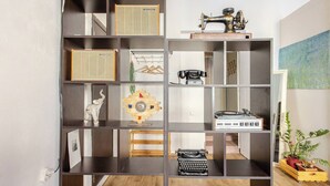 A modern, multi-shelved room with various items including a sewing machine, vintage radio, and typewriter. - Nice apartment with WiFi in charming T'bilisi (T'bilisi)
