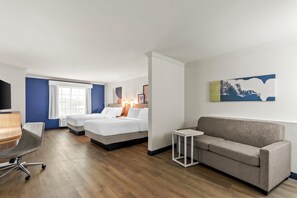 A hotel room with two beds, a sofa, a desk, and a TV. - Spark by Hilton Cincinnati Fairfield (Cincinnati)