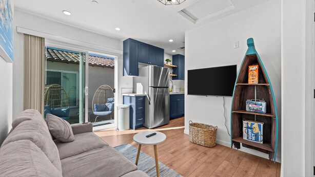 A modern living room with a sofa, a small round table, and a TV.