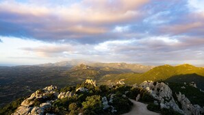 A mountainous landscape with rocky terrain and a dirt path.