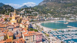 A coastal town with a marina, a church, and a mountain backdrop. - Lovely Studio In Mountain Village, Breil-sur-Roya, France (Breil-sur-Roya)