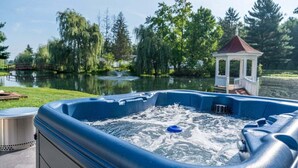 A hot tub with a clear view of a pond and gazebo in the background. - Amish Country Getaway w/ Hot Tub & Views (Applecreek)