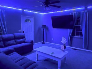 Relax in this stylish living room with a comfortable sofa, coffee table, and flat-screen TV.