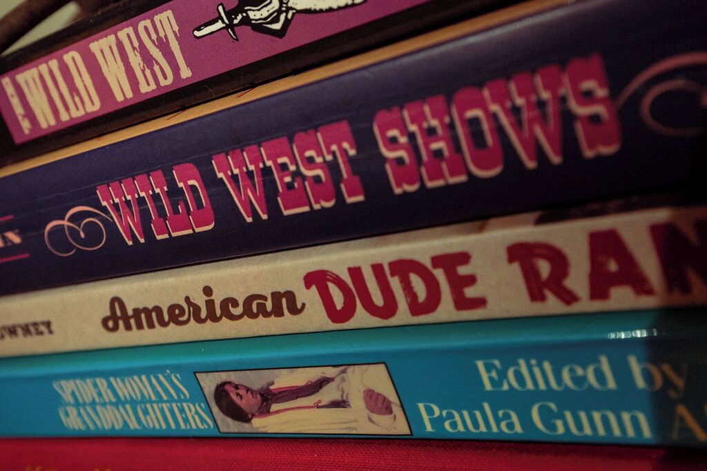 A stack of books with titles related to the Wild West.