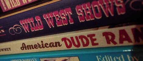 A stack of books with titles related to the Wild West.