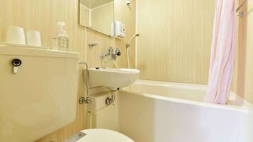 A bathroom with a toilet, sink, and bathtub.