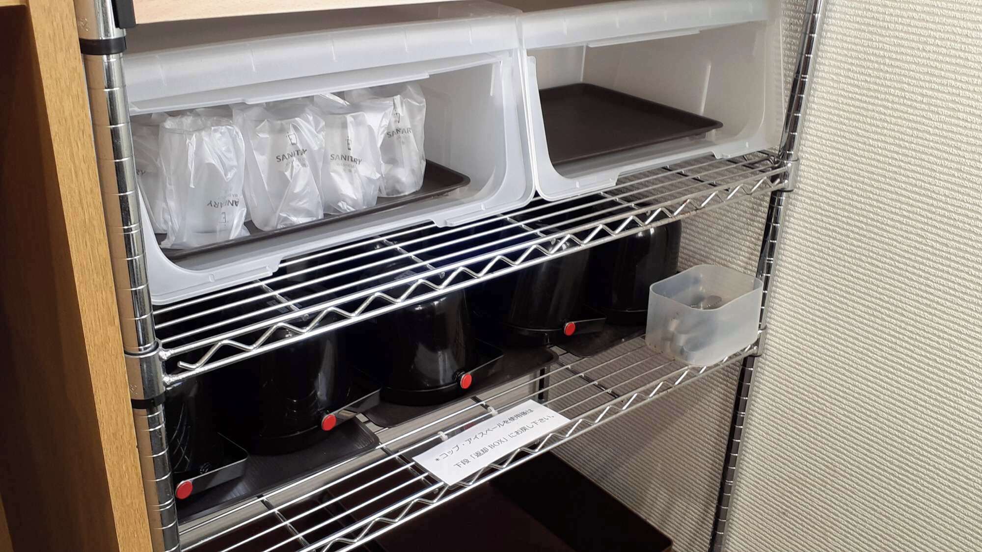 Un depósito con compartimentos para guardar objetos, incluyendo bolsas y recipientes de plástico.