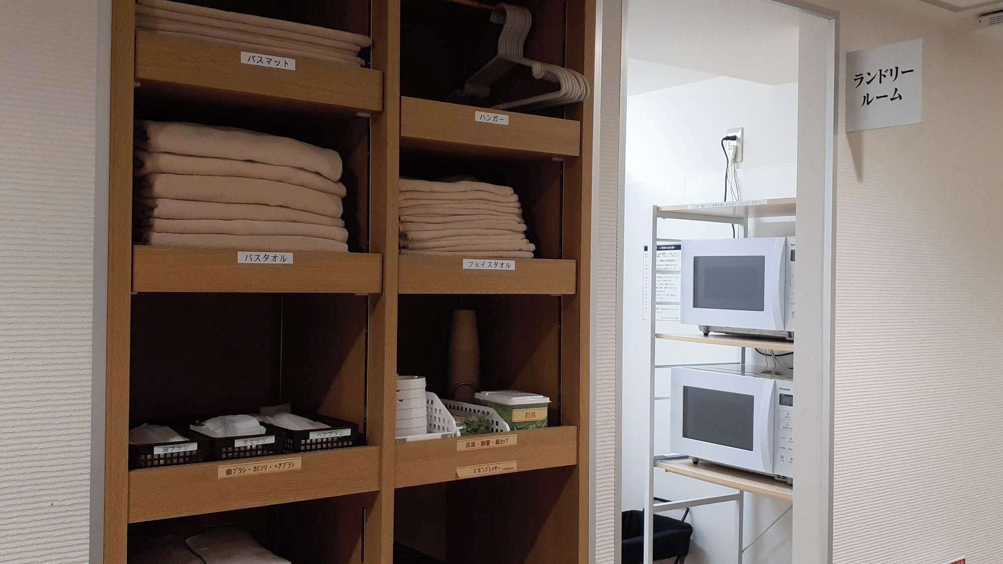 A storage room with shelves labeled for different types of bedding and linens.