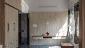A modern kitchen with wooden cabinets, a marble countertop, and a built-in oven. - Galaxy 4th Block by Red Olive (Bengaluru)