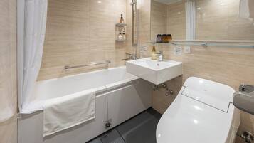 A modern bathroom with a bathtub, a sink, and a toilet.