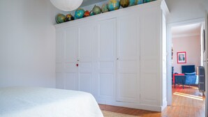 A bedroom with a bed, a wardrobe, and a globe collection on the wall. - Large apartment tastefully decorated for 5 people (Les Sables-d´Olonne)